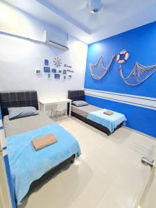 a hospital room with two beds and a table at Air-home No135 Kampung Boyan, 3BR, 6pax Netflix in Taiping