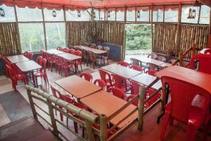 a group of tables and chairs in a room at Flagship Key 2 Heaven in Ooty