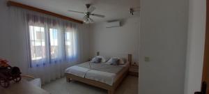 a bedroom with a bed and a ceiling fan at Holiday Home Latin in Peruški +26 photos