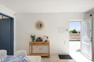 a bedroom with a table and a mirror on the wall at Maison Aveiro in Gafanha da Nazaré