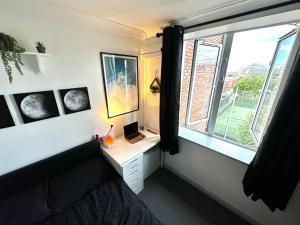 a bedroom with a window and a desk with a laptop at Custom House, 1 room, Dublin 1 in Dublin