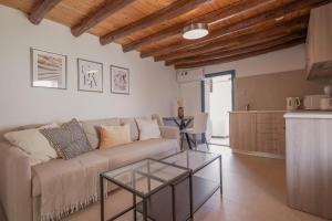 a living room with a couch and a table at Phaedrus Living: Peristerona Traditional Maisonette in Peristerona