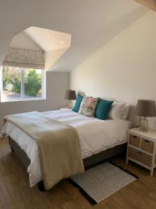 a white bedroom with a large bed and a window at Anchor's Rest in Hermanus