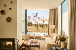 a living room with a couch and a fireplace at Octant Evora in Évora