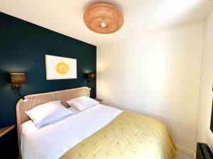 a bedroom with a bed with a blue wall at Centre ville AIX - Terrasse / Ascenseur - Rénové in Aix-en-Provence