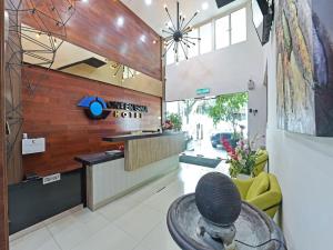 a lobby with a reception desk in a building at Capital O 90841 New One Enigma Hotel in Kuala Lumpur