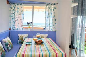 una mesa con un plato de comida y dos copas de vino en Bonita vivienda con vistas al mar playaWIFI, en Radazul