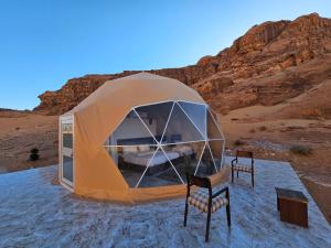 a tent in the middle of the desert at Mouna Luxury Rum Camp in Wadi Rum