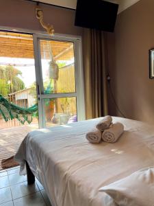 a bedroom with a bed with towels on it at Pousada Mundo Dha Lua in Sao Jorge