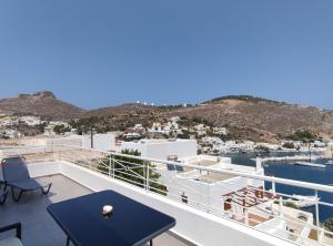 a balcony with a table and chairs and a view at Infinity Blue Suite in Panteli