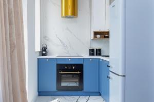 a kitchen with blue cabinets and a blue oven at Starowiślna Elegant Apartment with Air Conditioning Kazimierz Cracow by Renters Prestige in Krakow