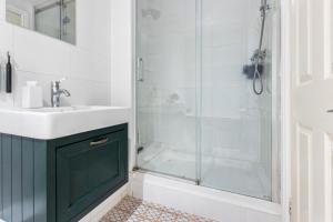 a bathroom with a sink and a shower at Lovely 2 bed Streatham apt with outside dining in London