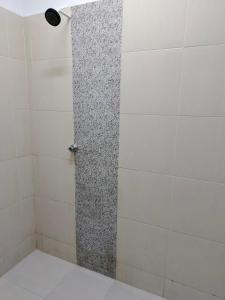a shower with a glass door in a bathroom at ZR Homestay in Jitra +2 photos