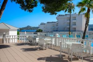 a row of tables and chairs on a patio at Hotel Vibra Riviera in San Antonio Bay