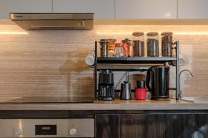 a kitchen counter with a coffee maker on a shelf at Lux Executive Residence @ Empire City by CIRCADIAN in Ho Chi Minh City