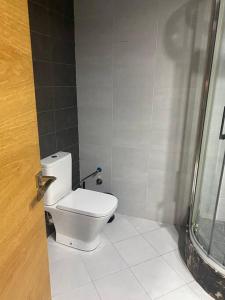 a bathroom with a white toilet and a shower at Appart de standing au centre in Casablanca