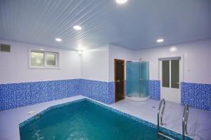 a blue and white bathroom with a swimming pool at Elite Art Hotel in Tashkent