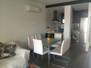 een keuken en eetkamer met een tafel en stoelen bij 2 bedroom apartment at Paradise Oasis Beach-ORIHUELA COSTA- LA ZENIA BEACH-ALICANTE in Orihuela-Costa