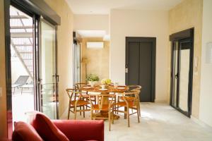 a dining room with a table and chairs at Cathedral Sevilla Views in Seville