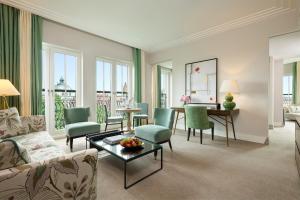 a living room with a couch and chairs and a table at Rocco Forte The Charles Hotel in Munich