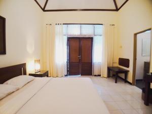 Katil atau katil-katil dalam bilik di Margo Utomo Hill View Resort