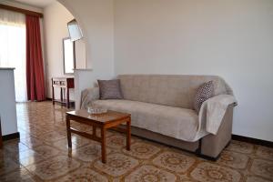 a living room with a couch and a table at Helena Apartments in Paradisi in Paradeísion