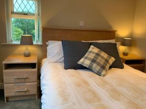 a bedroom with a bed with two lamps and a window at Stella Maris in Kircubbin