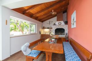 a dining room with a table and chairs and a fireplace at House Planika in Slano