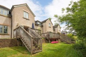 a house with two decks and a frisbee in the yard at Mill Village 75, Tide Cottage - P in Somerford Keynes