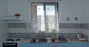 a kitchen with a sink and a window at Studios Soula in Alonnisos +32 photos
