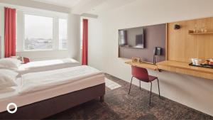 Postel nebo postele na pokoji v ubytování Center Hotels Plaza