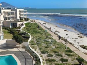 a view of the beach from the balcony of a building at Cape Beach Penthouse in Cape Town