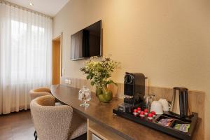 a hotel room with a counter with flowers on it at Hotel Fischzucht - by homekeepers in Würzburg