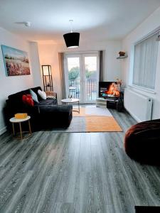 a living room with a couch and a fireplace at Swanky 1-Bedroom Apt in Walsall in Bescot