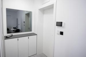 a bathroom with a sink and a mirror at Apartments M&A in Kaštela