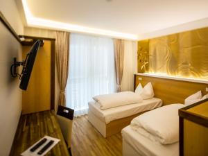Postel nebo postele na pokoji v ubytování Hotel Kiwano Graz