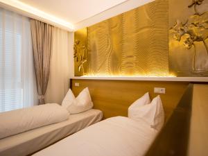 Postel nebo postele na pokoji v ubytování Hotel Kiwano Graz