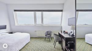 Postel nebo postele na pokoji v ubytování Center Hotels Plaza
