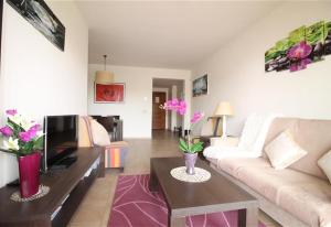 a living room with a couch and a tv at Apartment in La Cala de Mijas in La Cala de Mijas