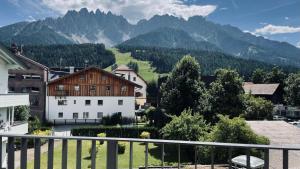 a view of a village with mountains in the background at Wachtler Dolomite Apartments in San Candido