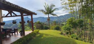 a porch of a house with a view of the mountains at Finca Buena Vista in Guatapé