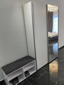 a dressing room with a mirror and a stool at Vista del Mar in Mamaia