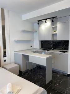 a white kitchen with a sink and a counter at Vista del Mar in Mamaia