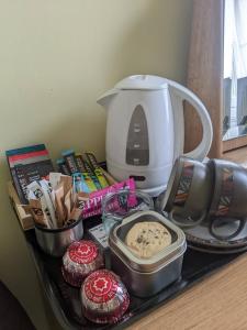 a tray with a coffee maker and food on a counter at McCrae's Bed and Breakfast in Edinburgh