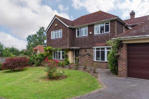 a brick house with a garage at Sycamores - Fabulous family home with huge garden in Kent