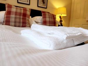 a pile of white towels sitting on top of a bed at Apartment 3 in Darlington