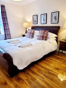 a large bed in a bedroom with a wooden floor at Apartment 3 in Darlington