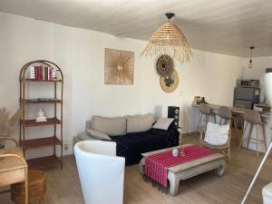 a living room with a couch and a table at Chez Berthe in Arles