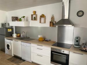 a kitchen with a sink and a stove top oven at Chez Berthe in Arles