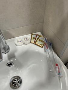 a sink with toothbrushes and other items on it at Sevan’s flat in Sevan